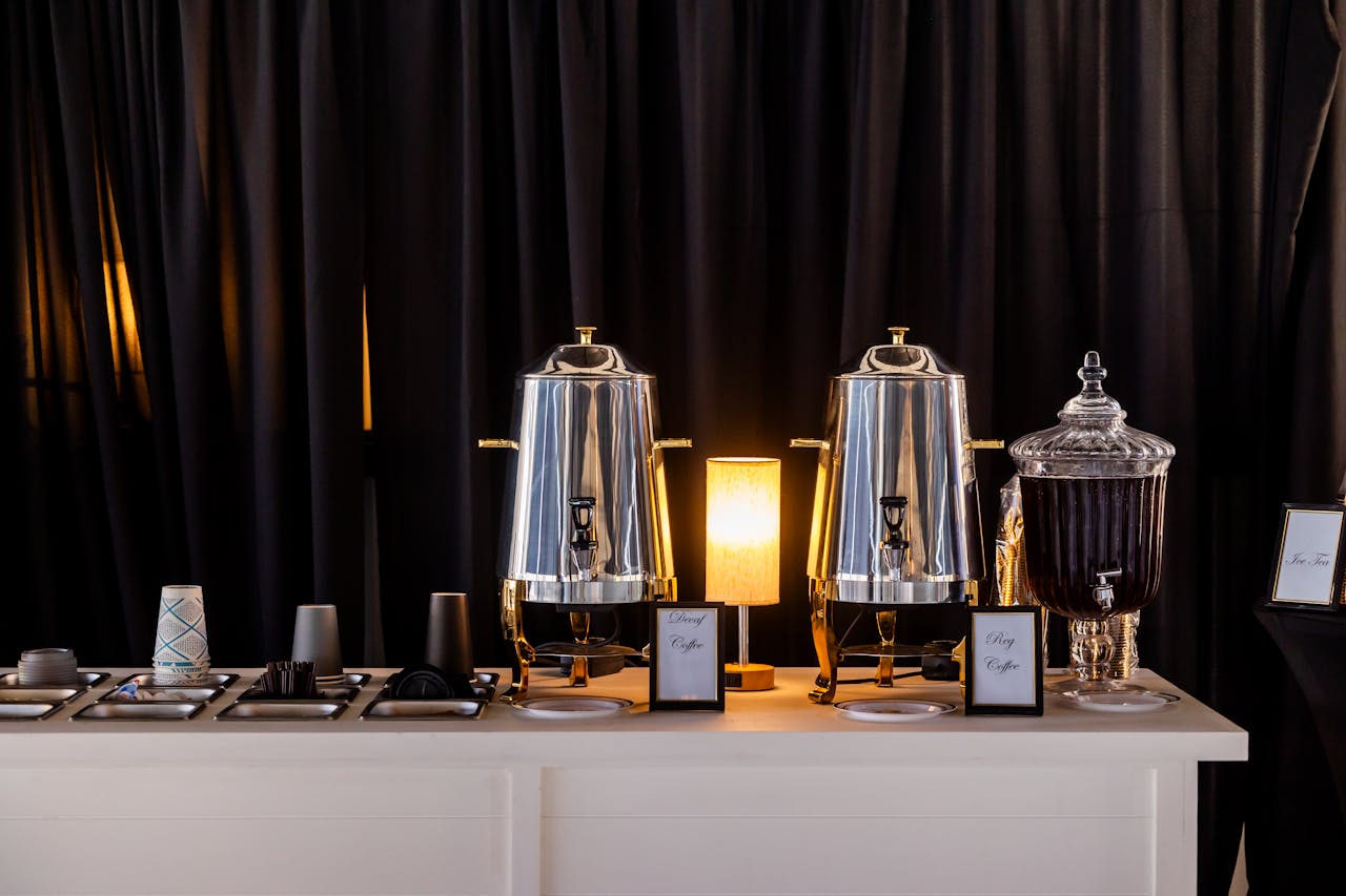 Stylish coffee station setup with polished dispensers and glassware for events.